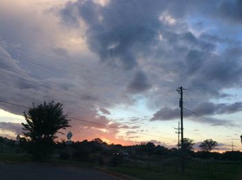 Silhouette of electricity pylon at sunset