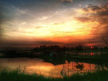 Scenic view of lake at sunset