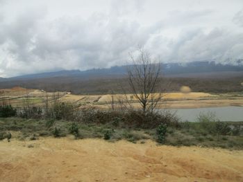 Scenic view of mountains against cloudy sky