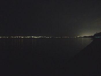 Reflection of illuminated sky on water at night