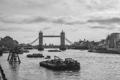 View of bridge over river against cloudy sky