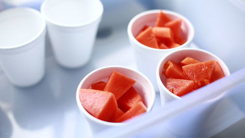 Close-up of papaya slices in cups