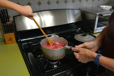 Midsection of man preparing food in kitchen