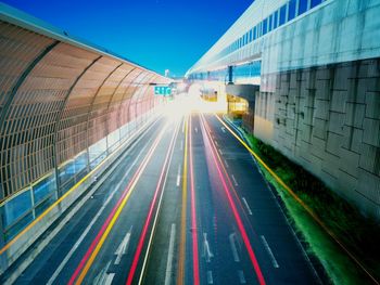 Light trails on road against sky in city