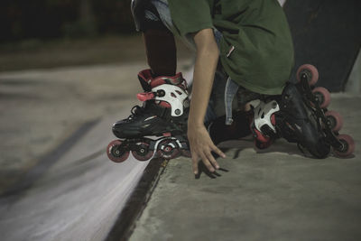 Low section of boy with roller skates in city