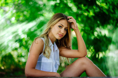 Portrait of young woman sitting outdoors