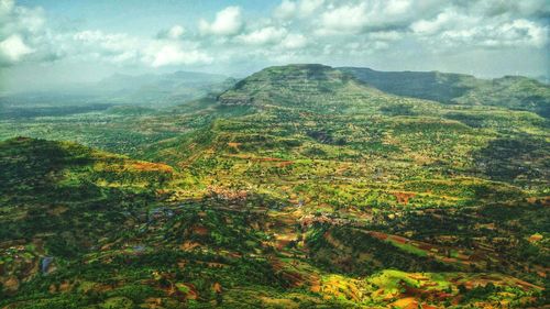 Scenic view of mountains against cloudy sky