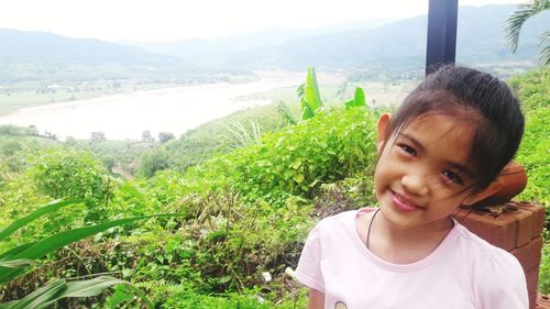 Beautiful young woman looking at mountains