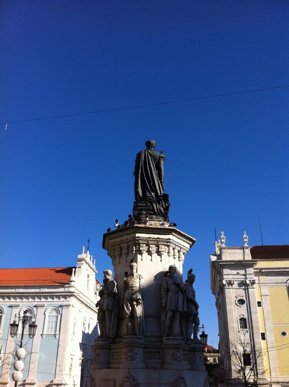 statue, human representation, sculpture, art and craft, art, creativity, architecture, building exterior, built structure, low angle view, clear sky, blue, animal representation, travel destinations, carving - craft product, famous place, city, history