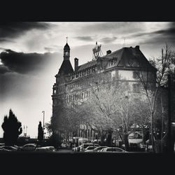 Buildings against cloudy sky