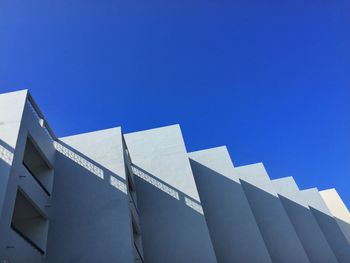 Low angle view of modern building against clear blue sky