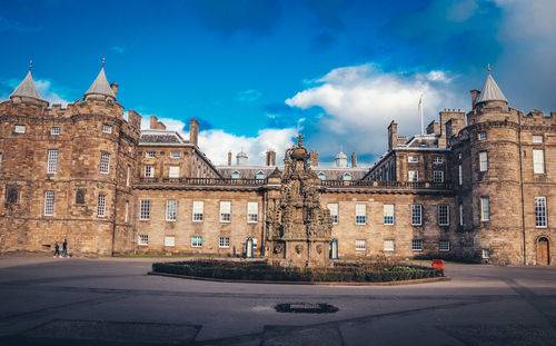 Buildings in city against blue sky