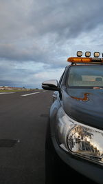 Vintage car on road against sky