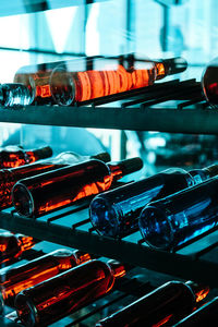 Wine bottles in shelves seen through glass