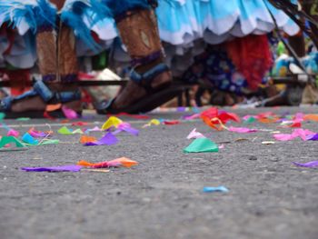 Close-up of small colorful papers on ground