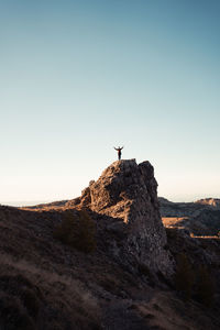 Rock formation on land against clear sky