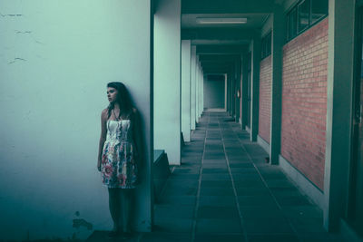 Woman standing in corridor of building