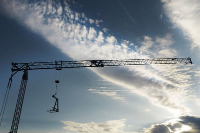 Photographic documentation of the silhouette of a construction crane at sunset