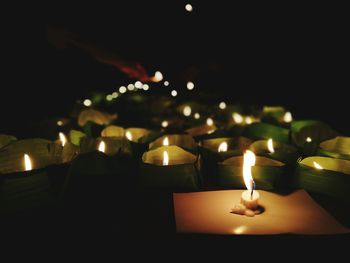 Close-up of illuminated candles on table