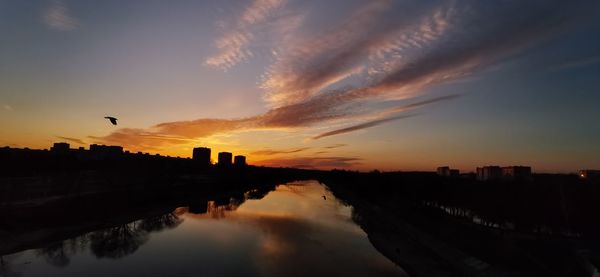 Silhouette buildings against sky during sunset