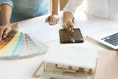 High angle view of people working on table