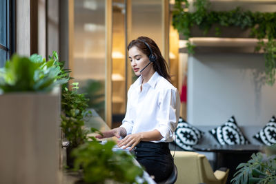 Young woman working at the wall