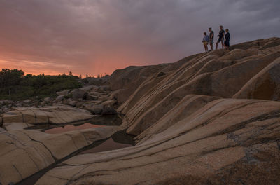 Rear view of man standing on rock formations