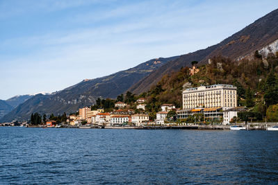 Scenic view of sea by buildings against sky