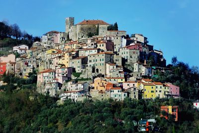Buildings in city against clear sky