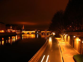 Illuminated street light by river at night