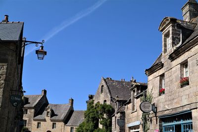 Low angle view of buildings against clear blue sky