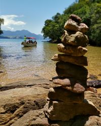 View of rocks in lake against sky