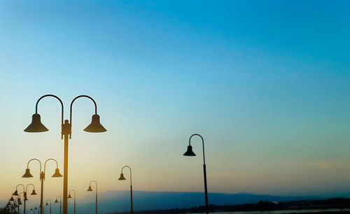 Silhouette of street lights during beautiful sunset