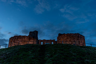 Low angle view of castle against cloudy sky