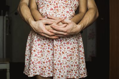 Midsection of woman standing at home