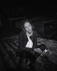 Portrait of young woman sitting outdoors