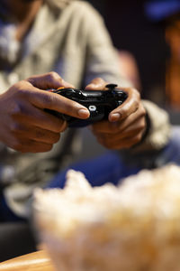 Midsection of man using mobile phone