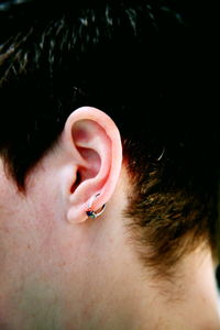 Close-up of man wearing earring