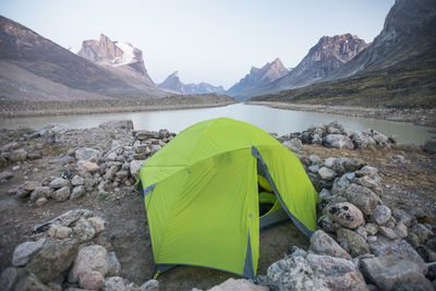 Camping tent perched above summit lake in auyuittuq national park