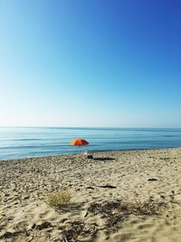 Scenic view of beach against clear sky