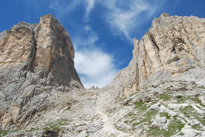 Low angle view of rocky mountains against sky