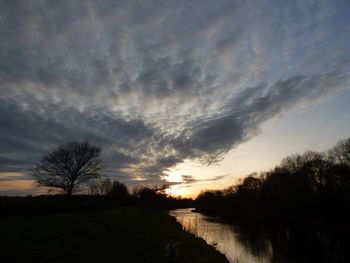 Scenic view of silhouette trees against sky at sunset