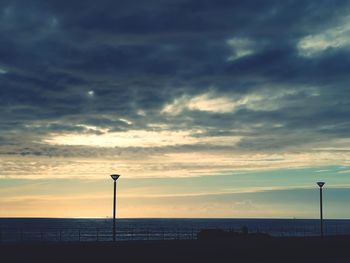 Silhouette street light against sky during sunset