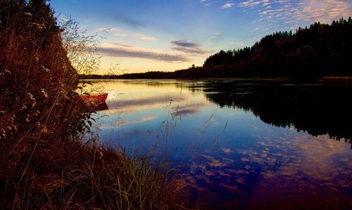 Scenic shot of calm lake at sunset