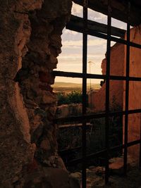 Rock formation against sky seen through window