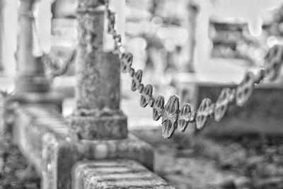 Close-up of metal chain against building