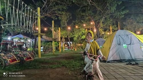 Man sitting by plants at night