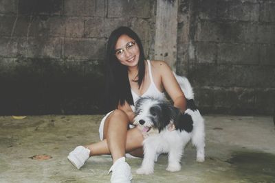 Portrait of young woman with dog