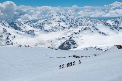 Group of people on snow covered mountain