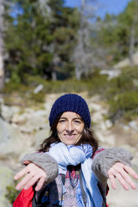 Portrait of smiling woman in forest during winter